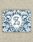 A NMJL Mahjong card cover sticker with a navy blue and white floral damask pattern and personalized with a two-letter monogram.
