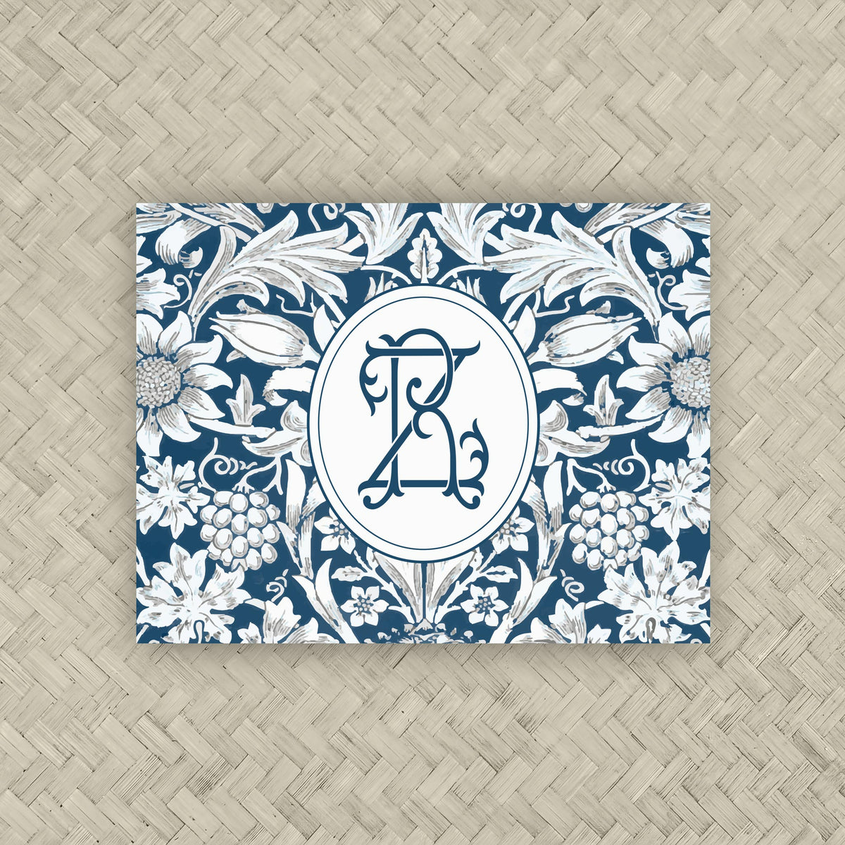 A NMJL Mahjong card cover sticker with a navy blue and white floral damask pattern and personalized with a two-letter monogram.