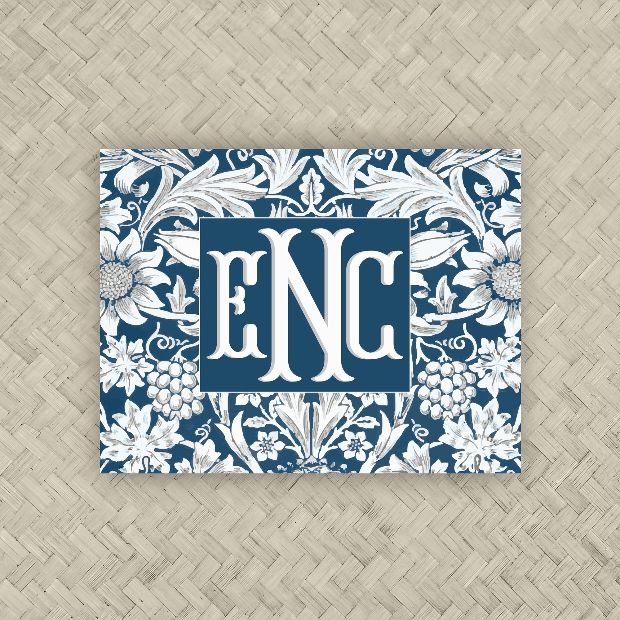 A NMJL Mahjong card cover sticker with a navy blue and white floral damask pattern along the border, personalized with a three-letter monogram in white serif letters against a navy blue background.